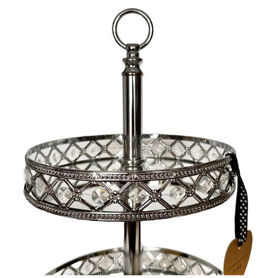 Decorative two-tiered stand with crystal accents on a white background