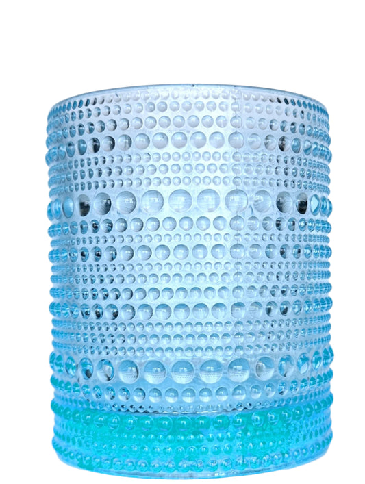 Blue hobnail stemless wine glass on a white background