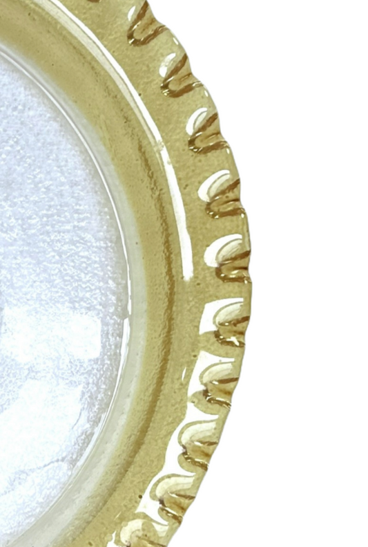 Decorative round object with gold rim and white center on a white background