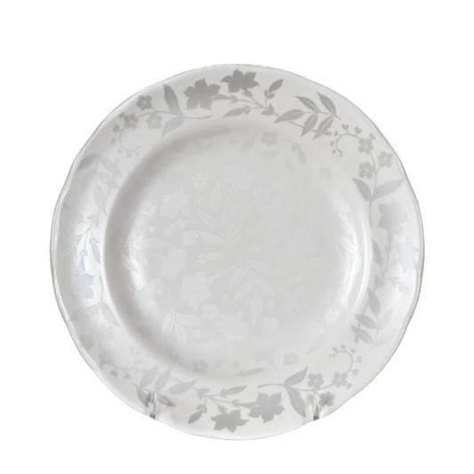 White ceramic plate with floral patterns on a white background