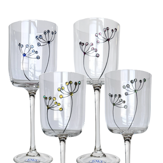 Set of four wine glasses with decorative designs on a white background