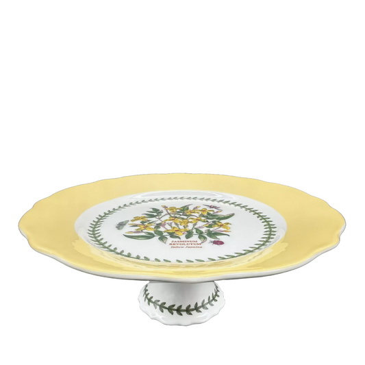 Yellow ceramic cake holder with green leaf pattern