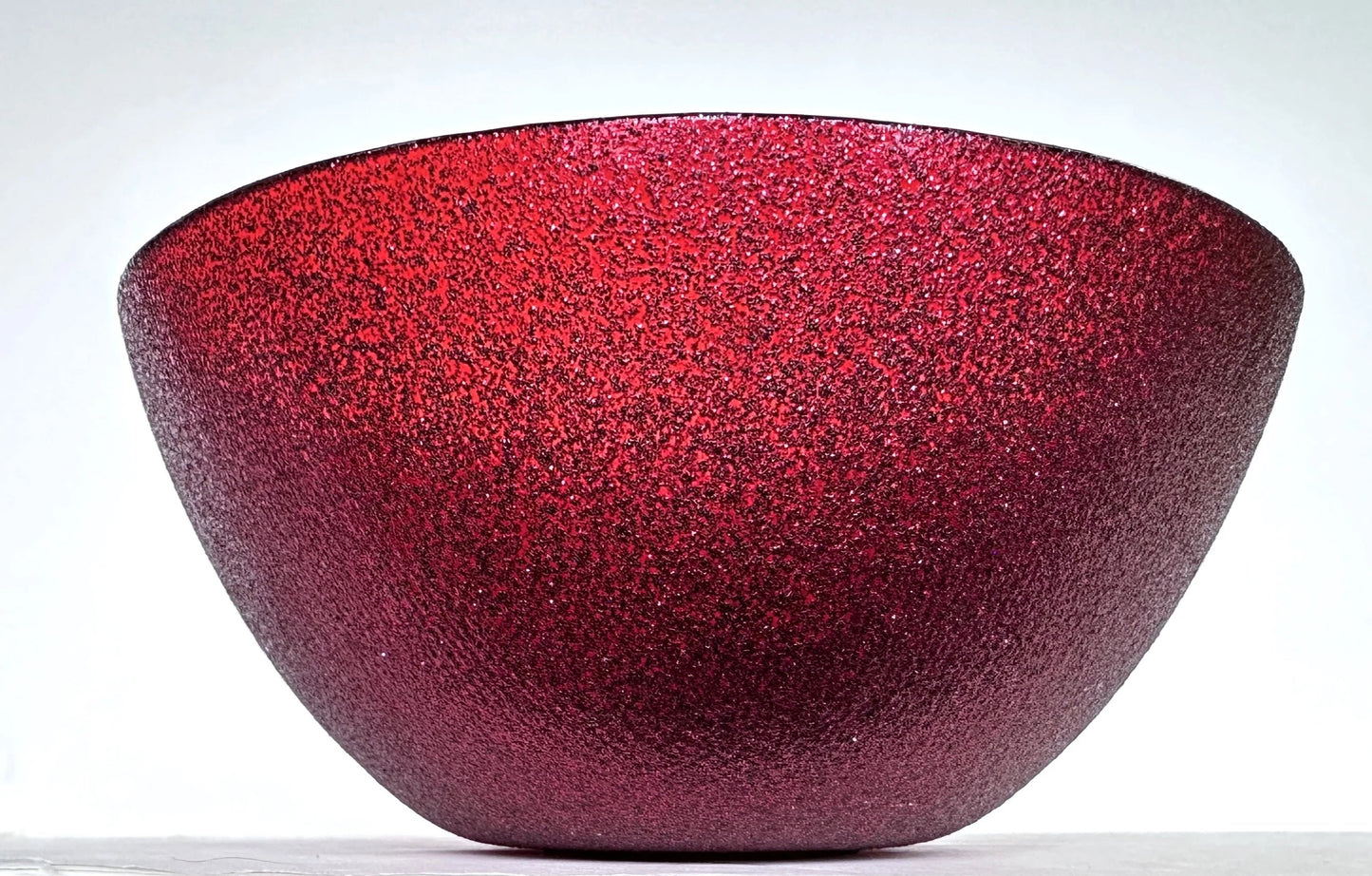 Red glass bowl with speckled texture 