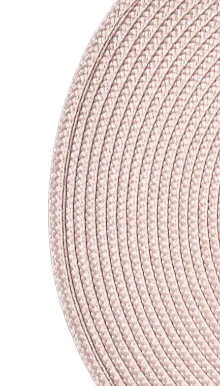 Close-up of pink braided placemat on a white background