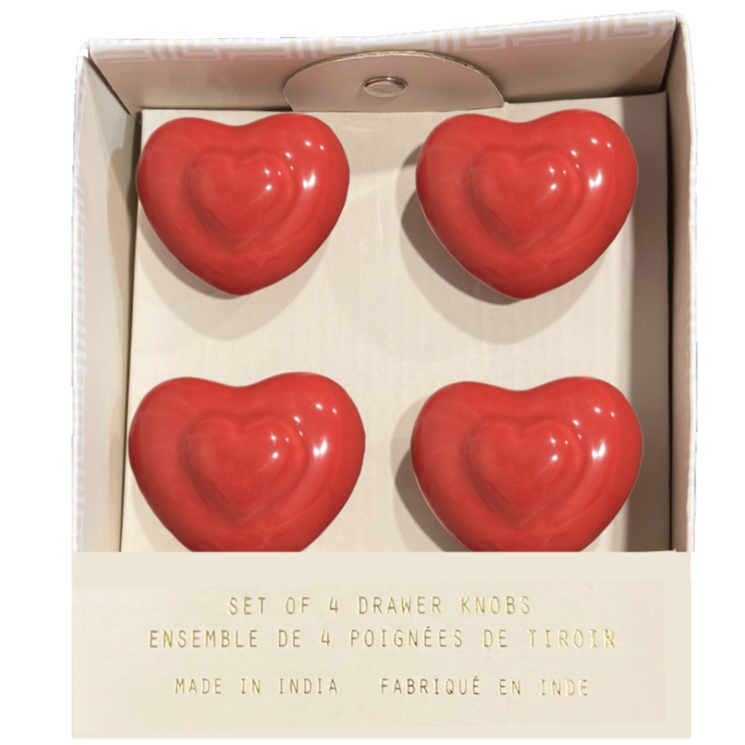 Set of four red heart-shaped drawer knobs in a box 