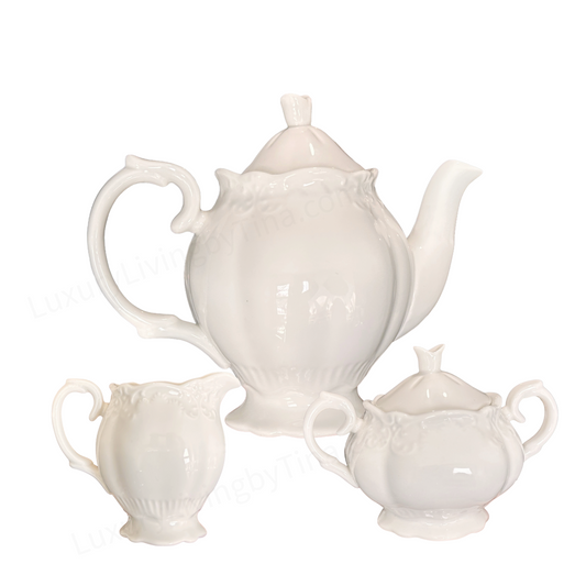 White Porcelain Tea Service with Curved Spout, Ornate Handle, And Domed Lid