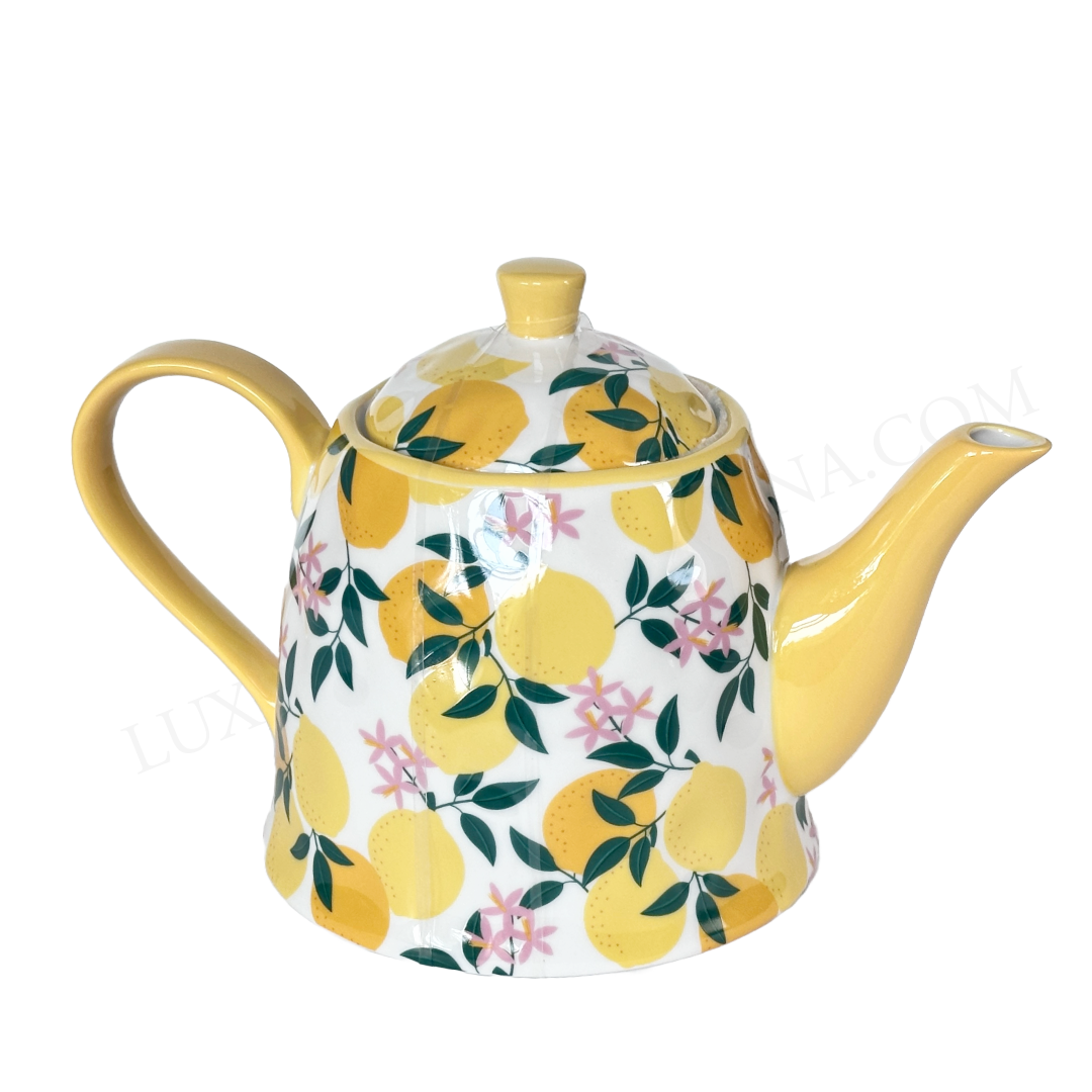 Teapot with lemon and floral pattern on a white background