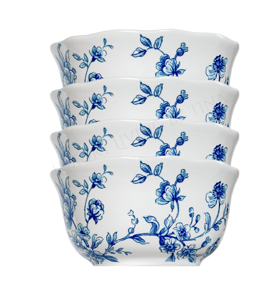 Set of four white bowls with blue floral patterns on a white background