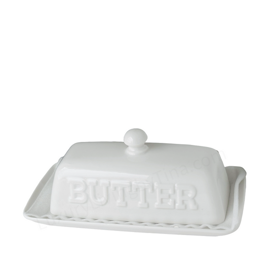 White ceramic butter dish with 'BUTTER' embossed on it on a white background