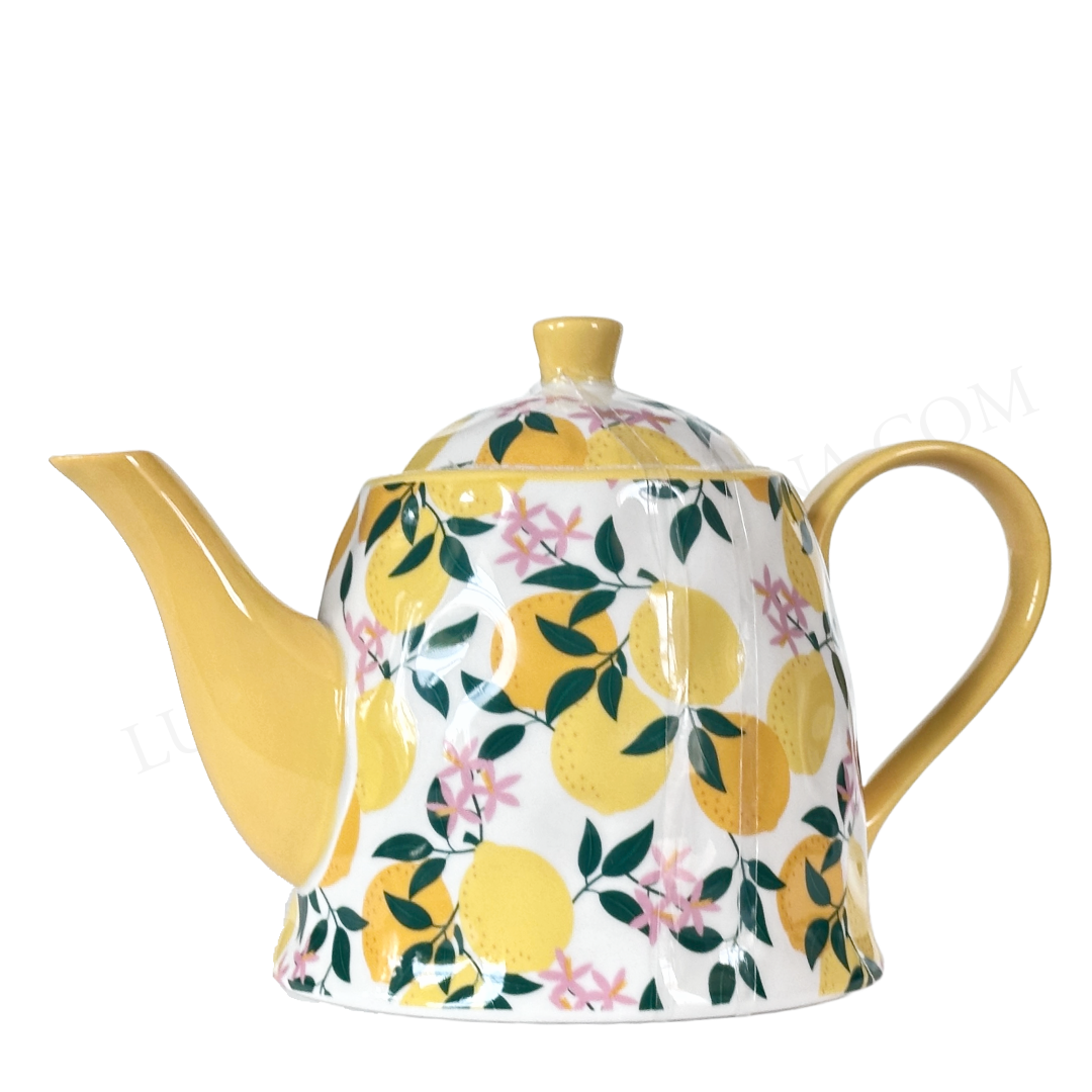 Teapot with lemon and floral pattern on a white background