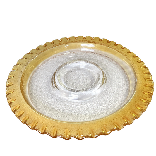 Clear glass plate with gold rim on a white background