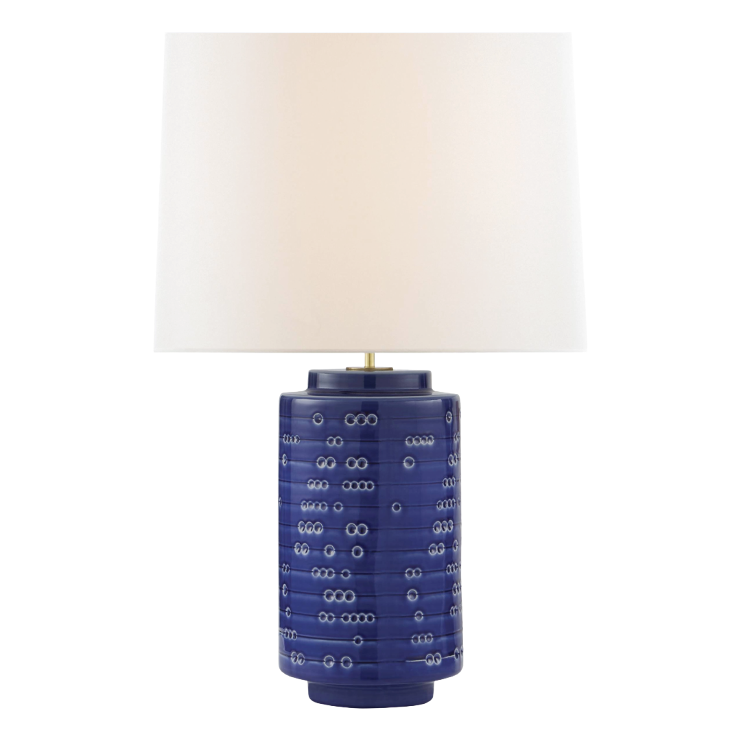 Table lamp with a blue ceramic base and white shade on a white background