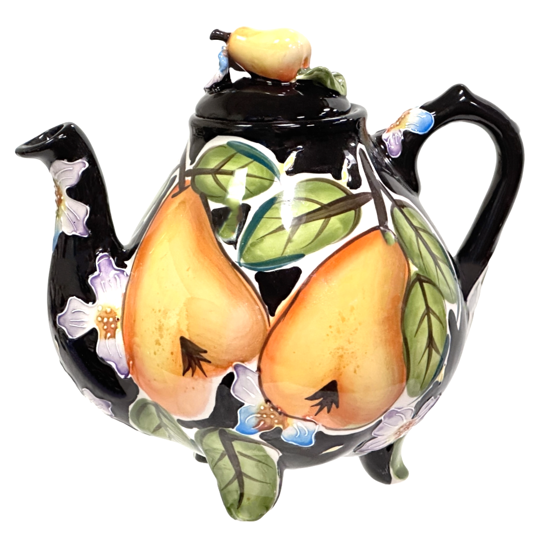 Ceramic teapot with pear design on a white background